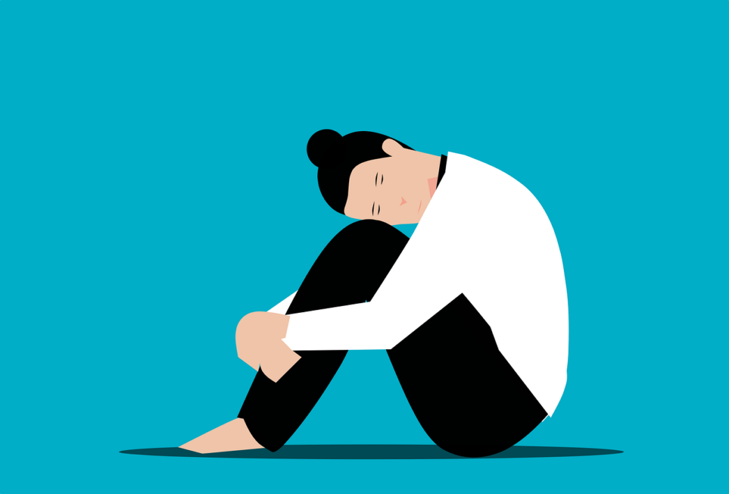 Illustration of a woman in a white shirt and black pants sitting on the ground with her knees up and her head on her knees in stress.