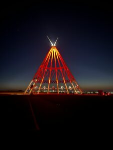 The Saamis Tepee landmark is lit up red for FASD Day against the nighttime sky.