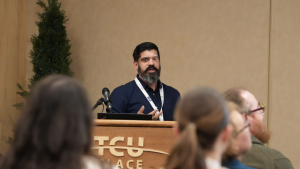 Man presents at a conference