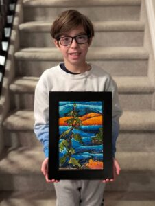 Korben holding his painting.